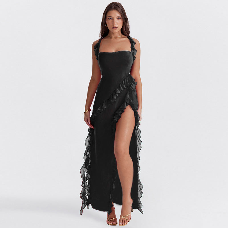 Woman wearing a black dress with ruffled details on a white background