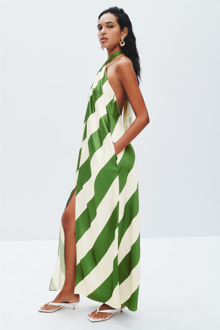 Woman wearing a green and white striped dress on a white background