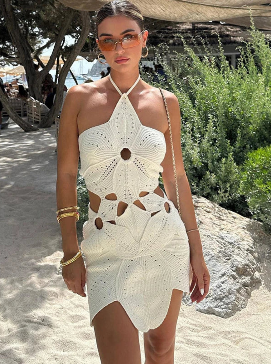 Side profile of boho-style white crochet mini dress showing elegant waist cutouts and handmade pattern for summer style inspiration