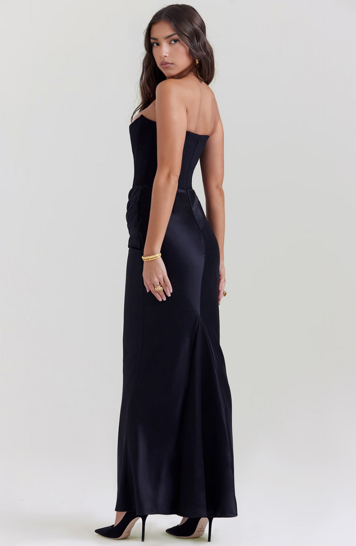 Woman wearing a black evening gown on a white background