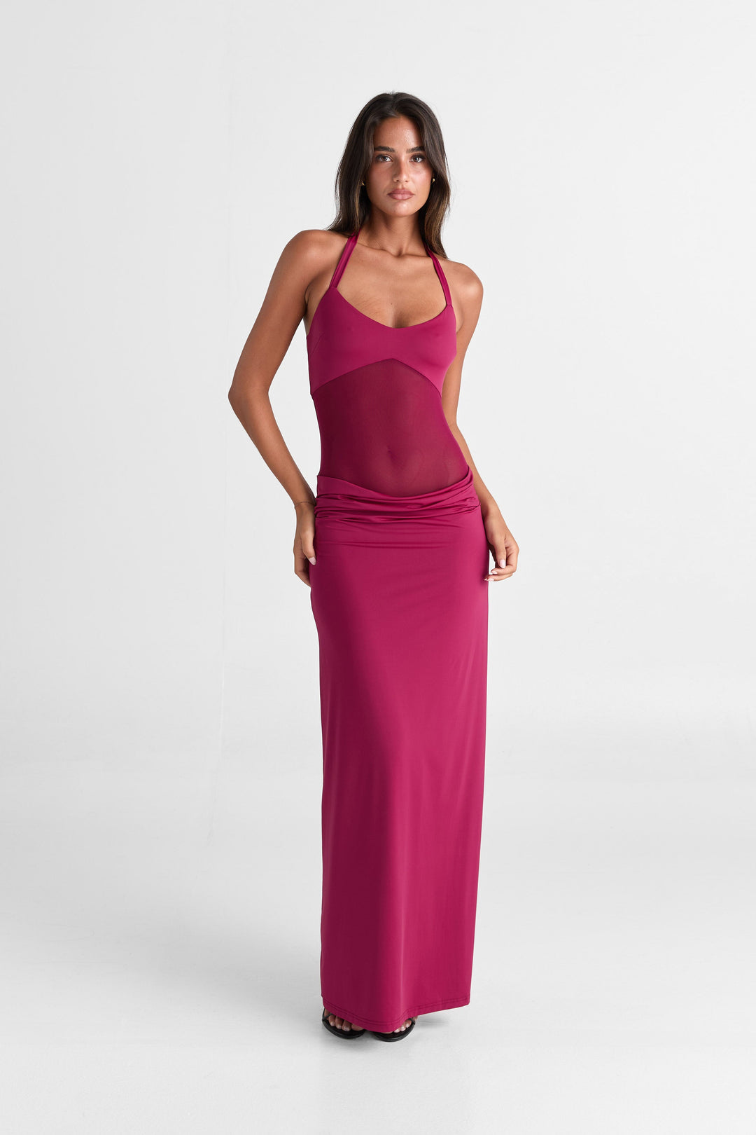 Woman wearing a pink dress on a white background