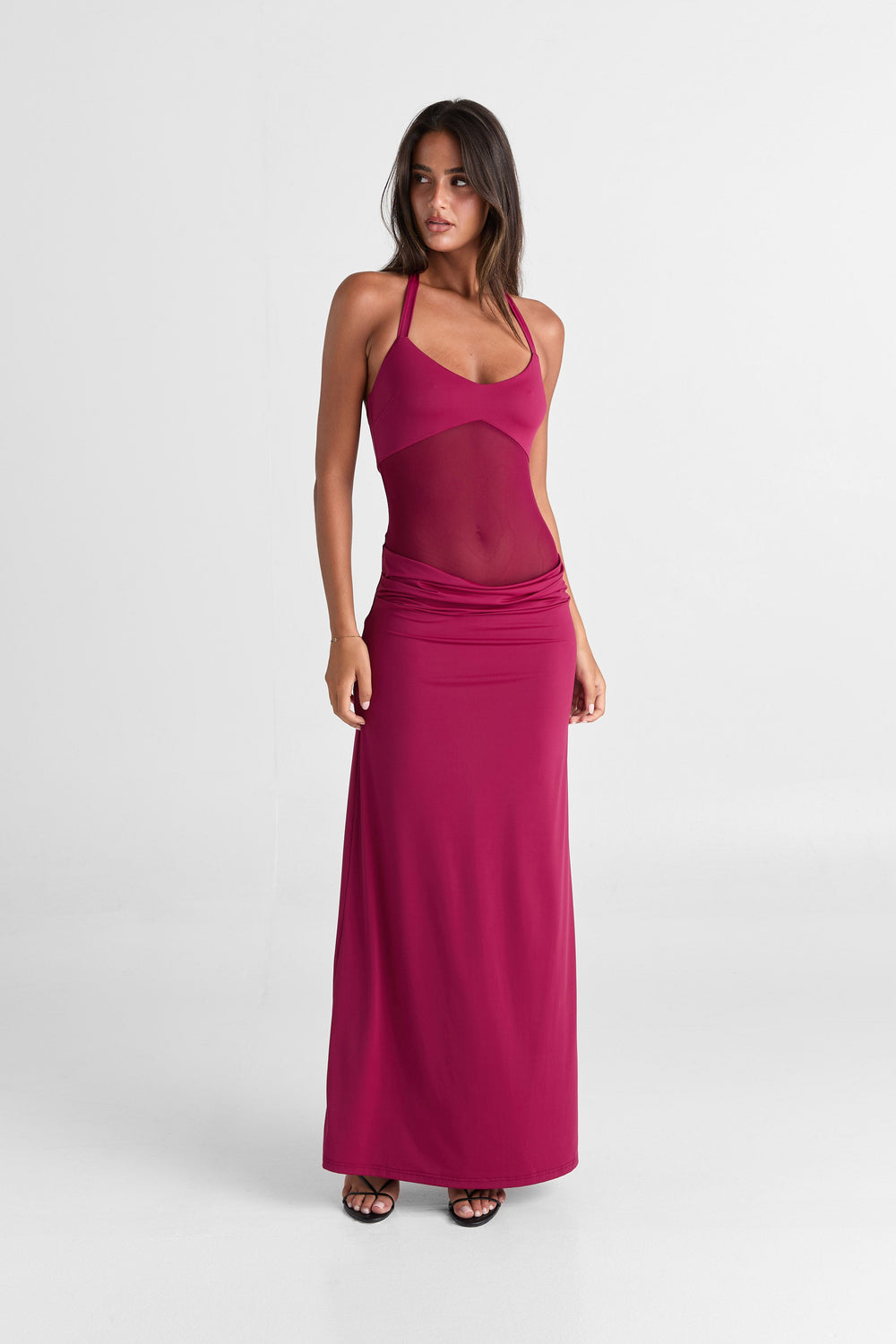 Woman wearing a pink dress on a white background