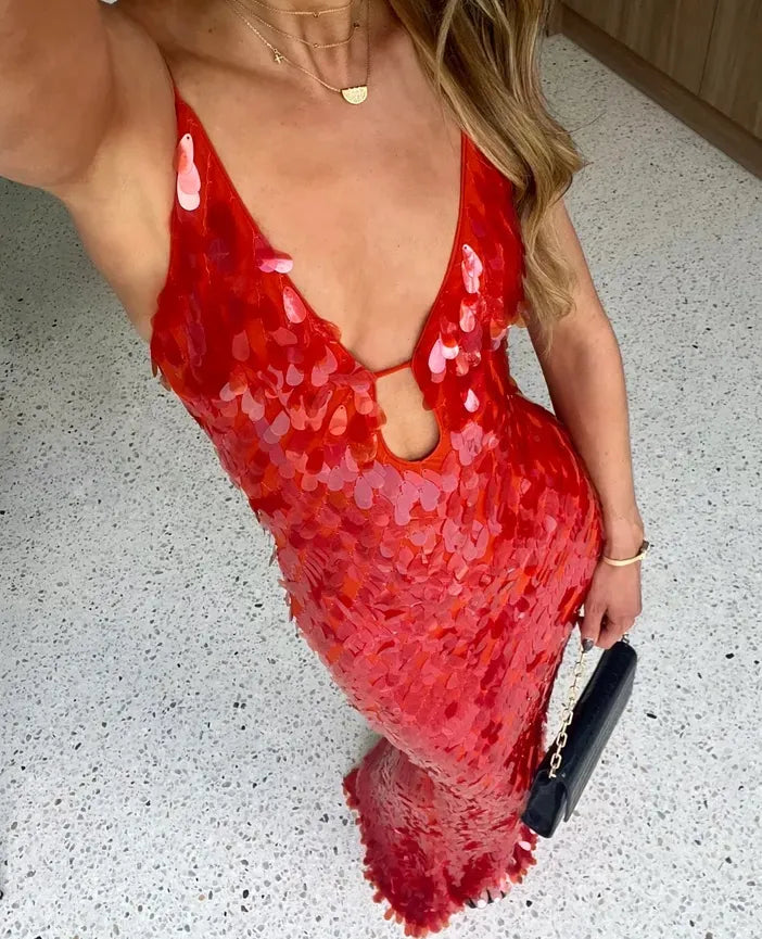Red sequin dress worn by a person on a light gray floor.