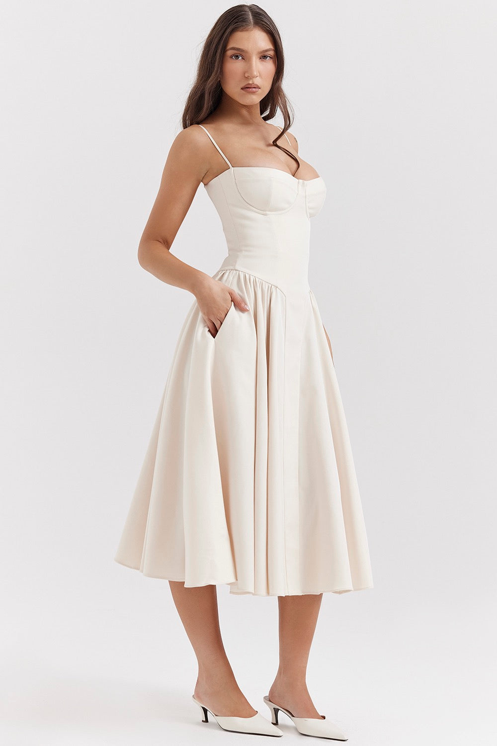 Woman wearing a white dress on a plain background