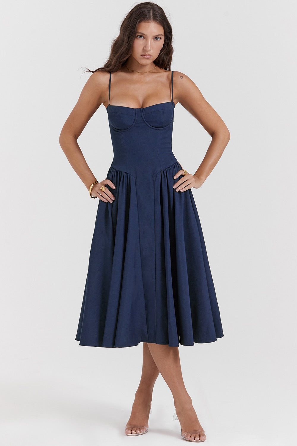 Woman wearing a navy blue dress on a white background