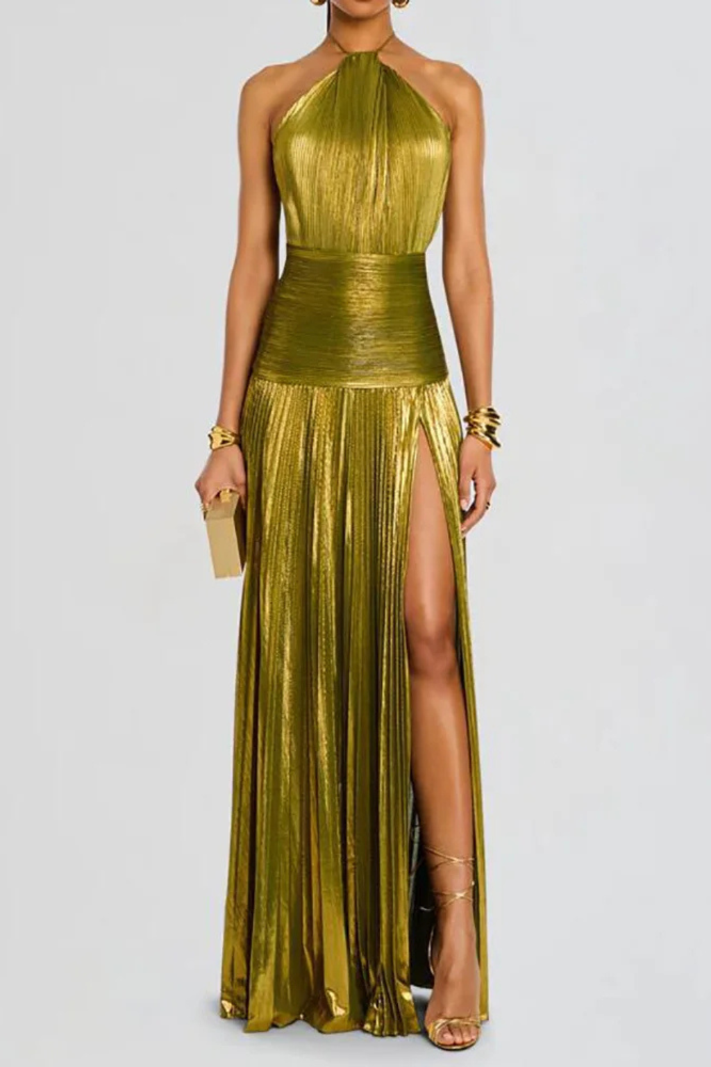 Gold metallic halter neck gown with a high slit on a white background