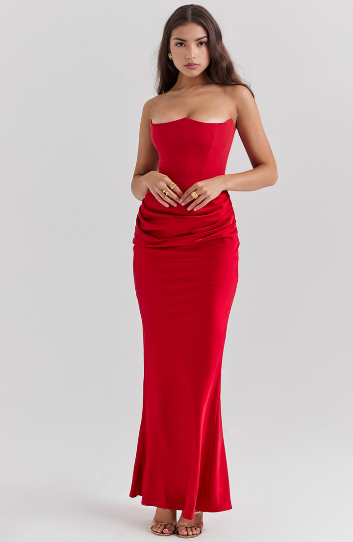 Woman wearing a strapless red dress on a white background