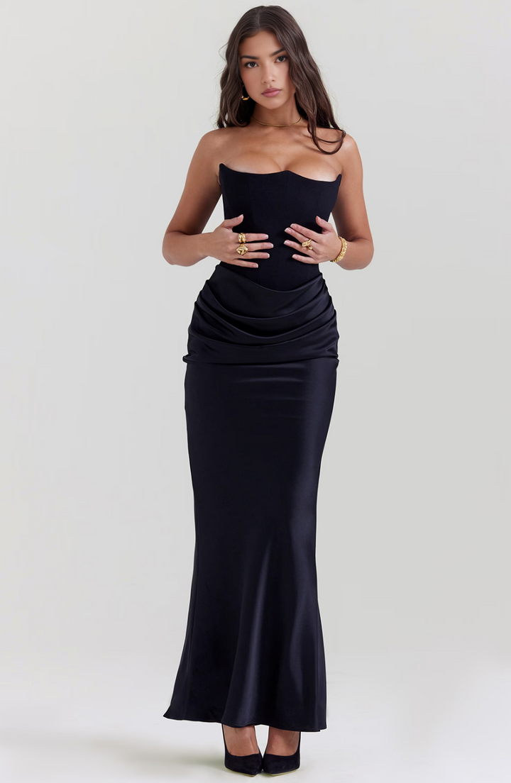Woman wearing a black strapless gown on a white background