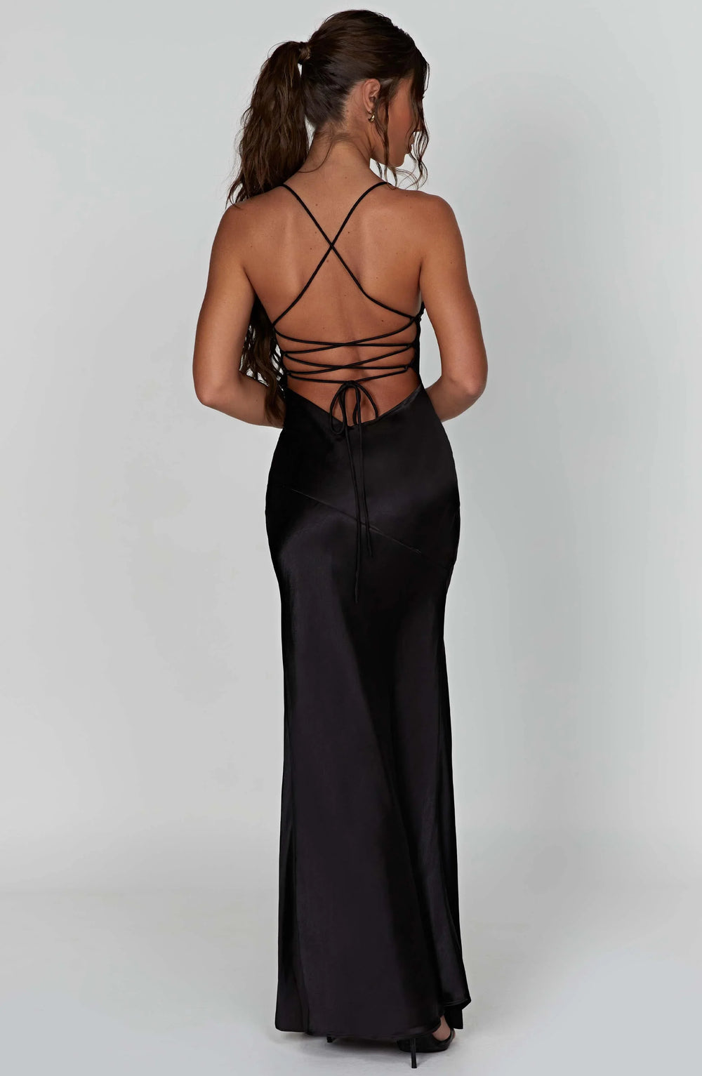 Black evening gown with open back on a white background