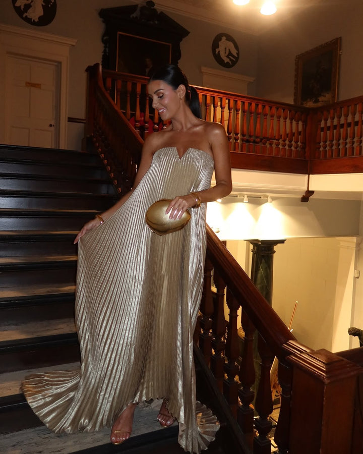 Lightweight satin maxi dress shining under sunlight, styled with minimal accessories