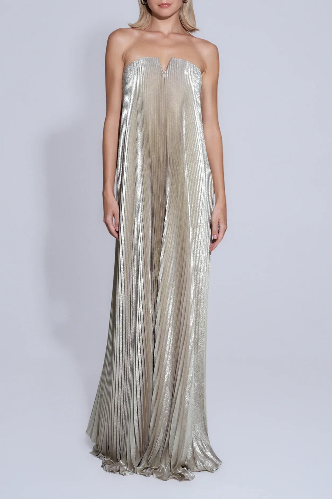 Model wearing gold satin maxi dress with sweetheart neckline in natural sunlight