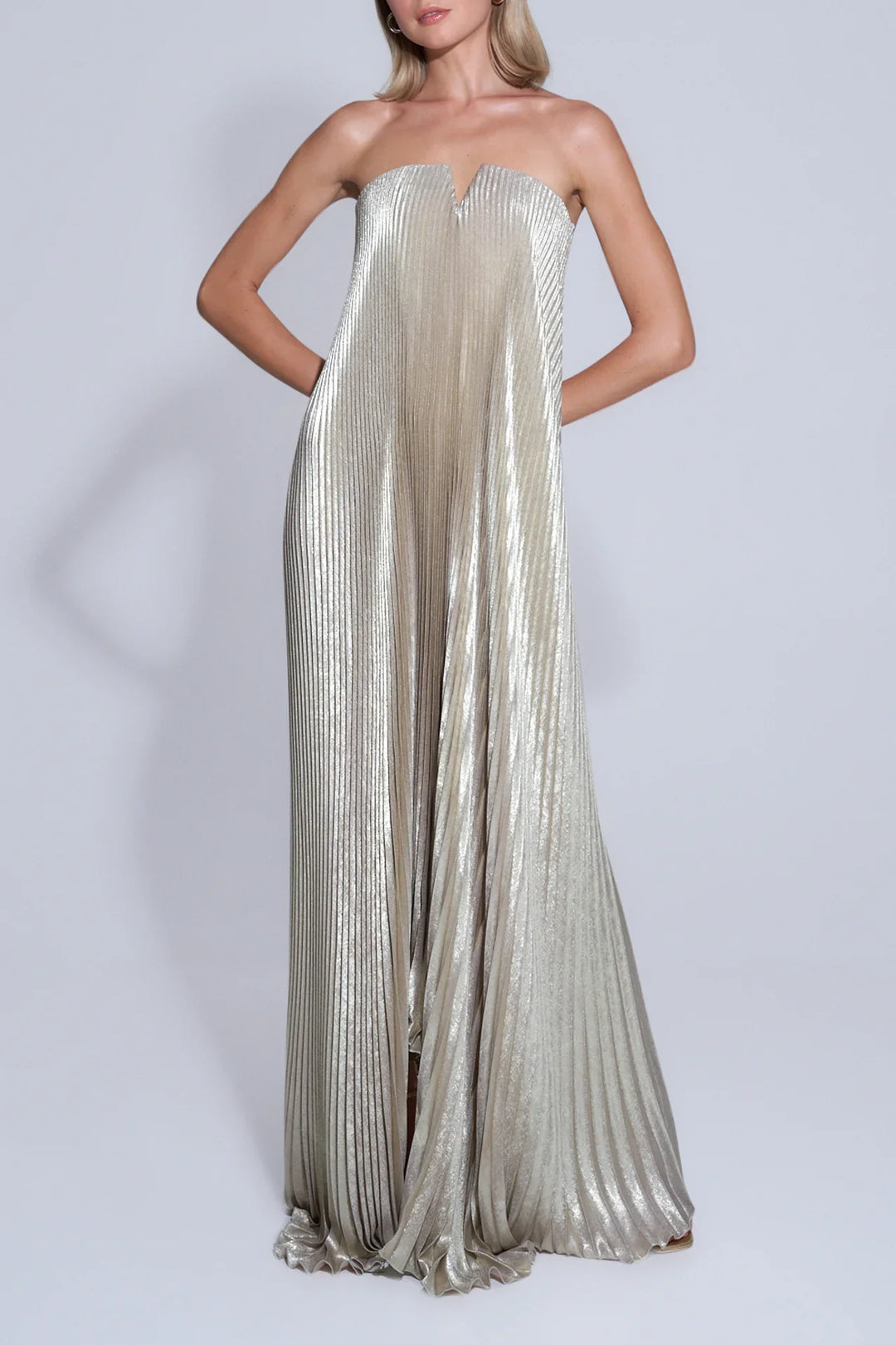 Model wearing gold satin maxi dress with sweetheart neckline in natural sunlight