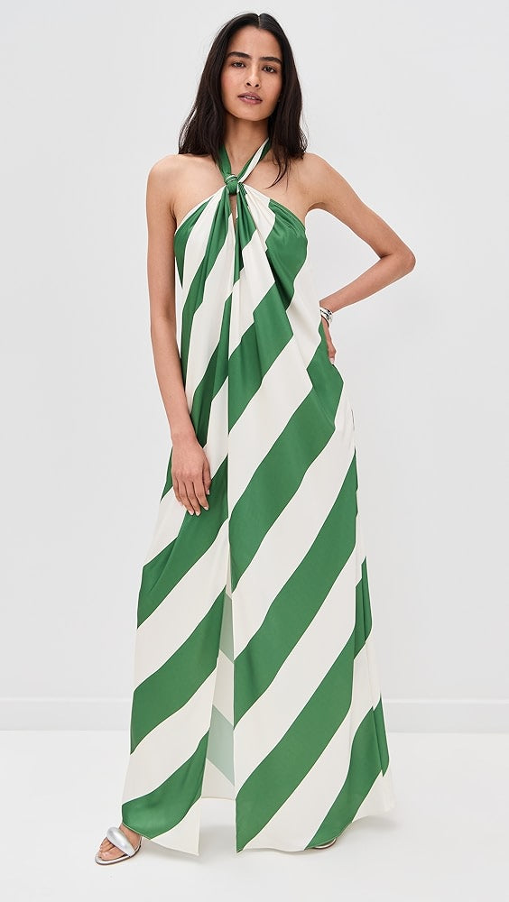 Woman wearing a green and white striped halter neck dress on a white background
