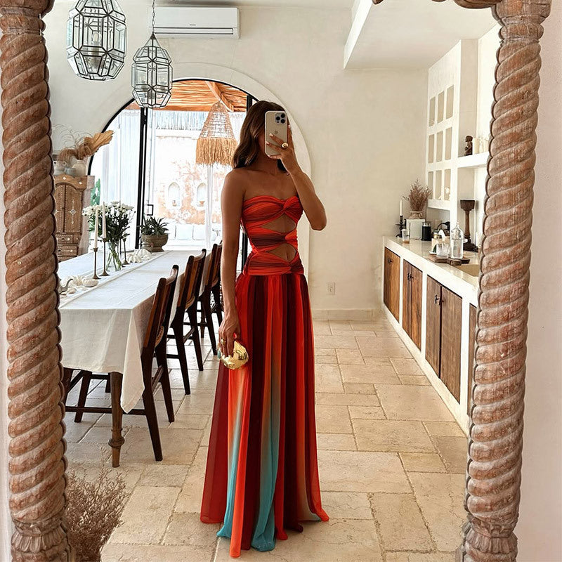 Woman in a red dress taking a mirror selfie in a stylish interior setting.