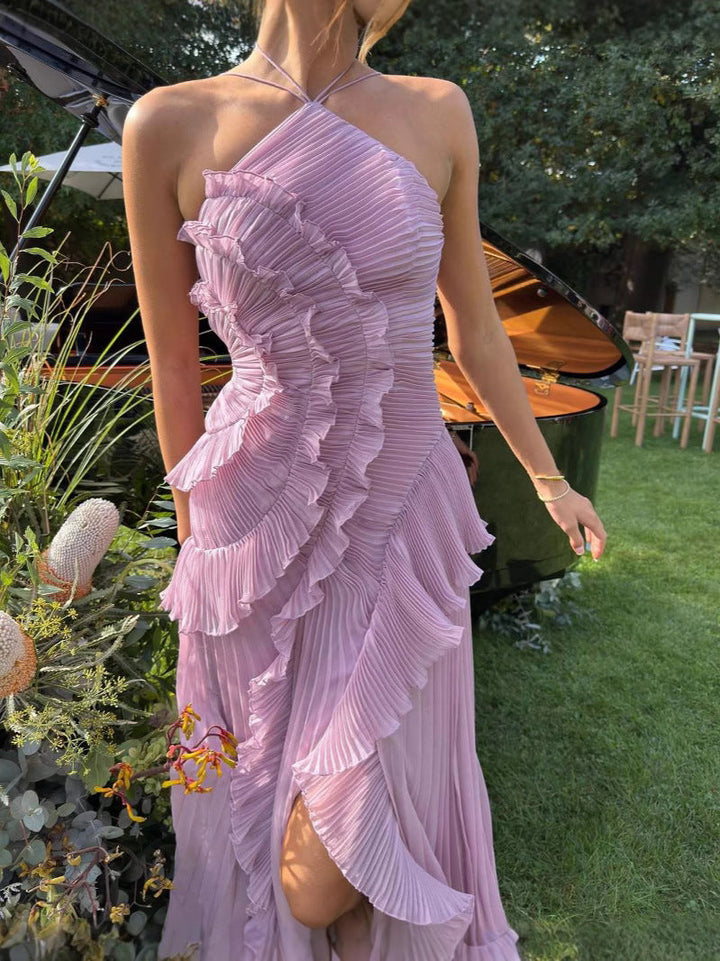 Woman wearing a pink ruffled dress in an outdoor setting