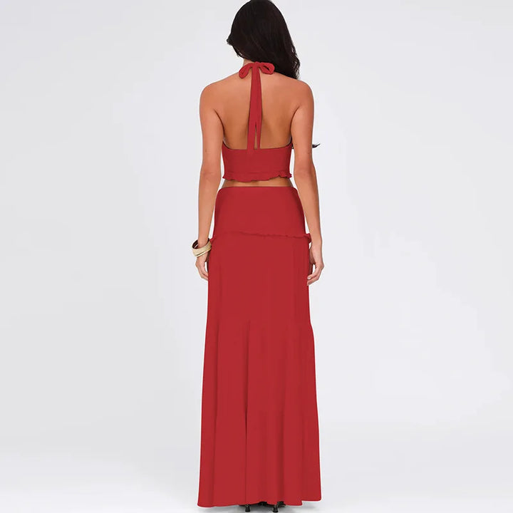 Red two-piece outfit with a halter top and long skirt on a white background