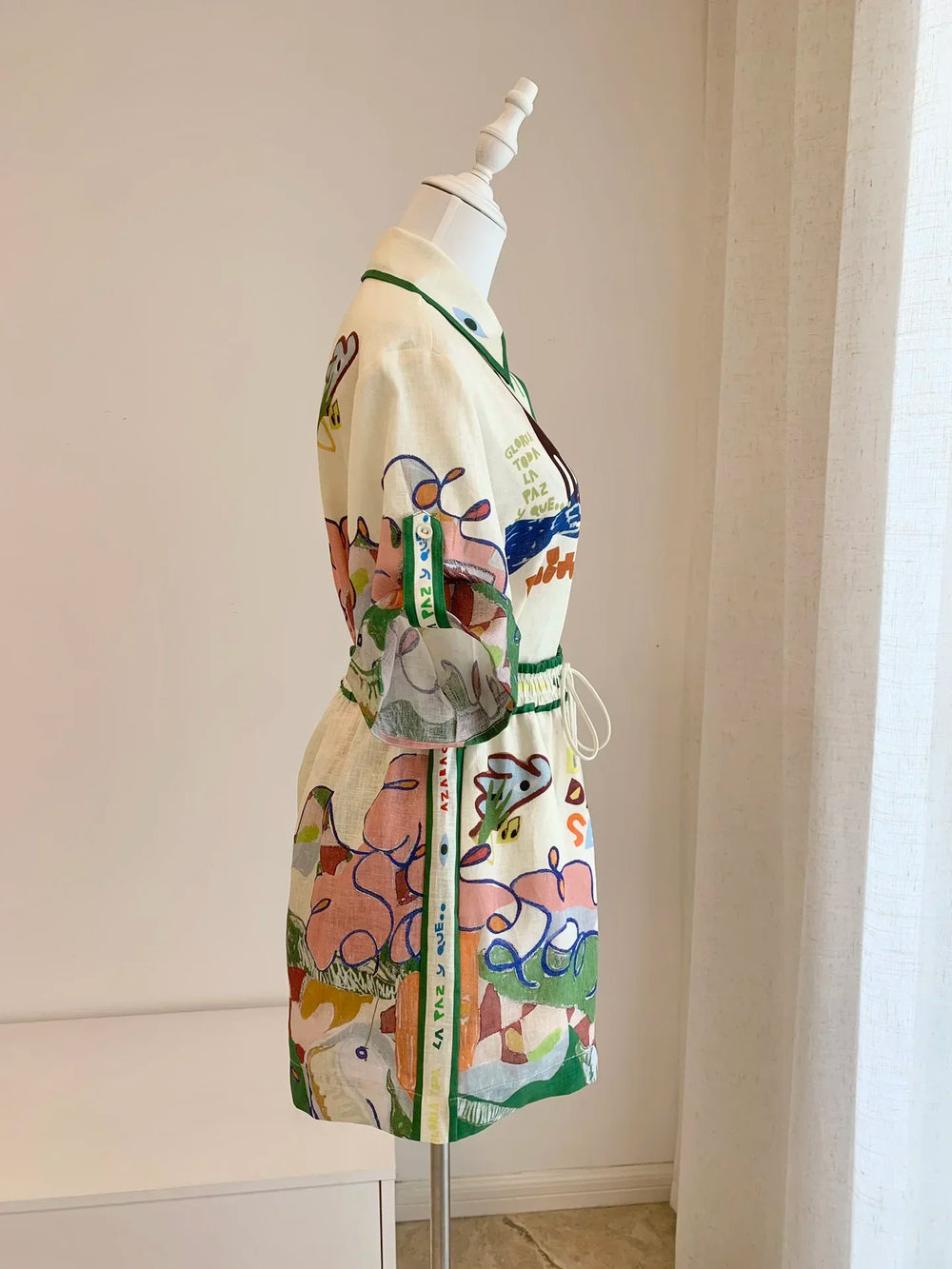 Colorful dress on a mannequin against a neutral wall