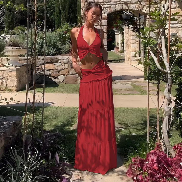 Woman in a red dress standing in a garden setting