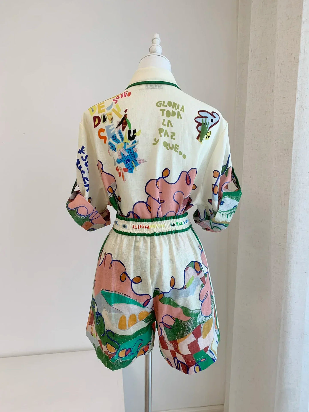 Colorful outfit with teddy bear design on a mannequin against a white background