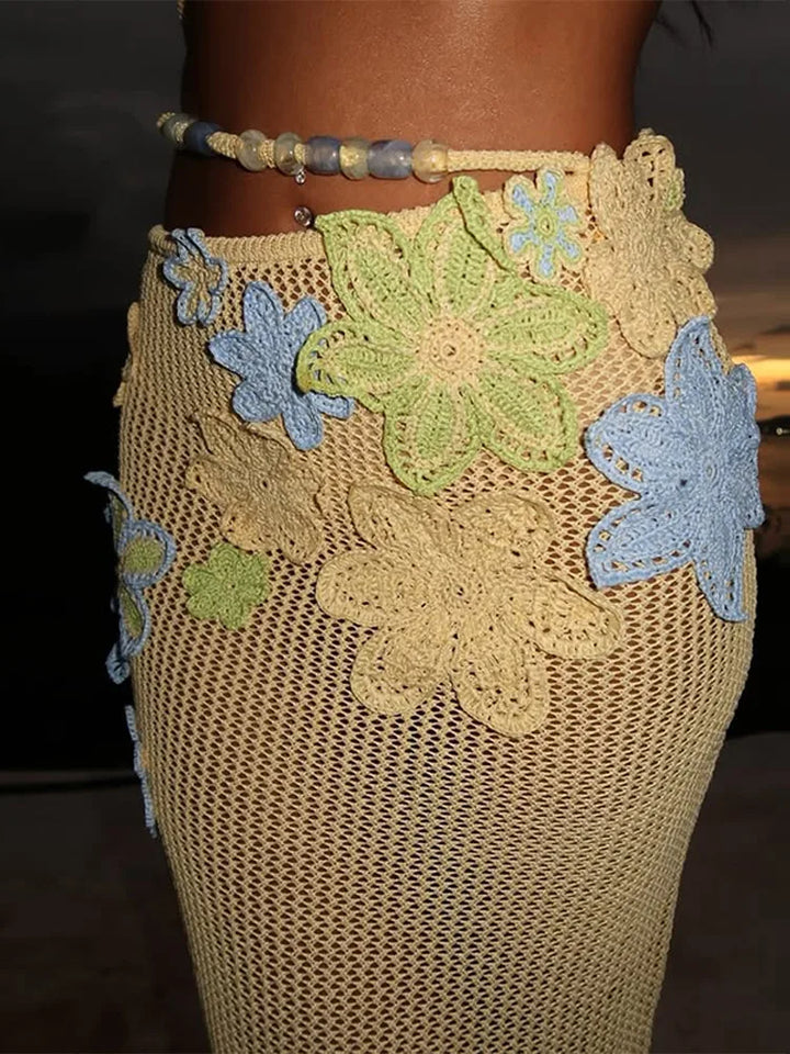 Beige skirt with floral patterns and beads on a dark background
