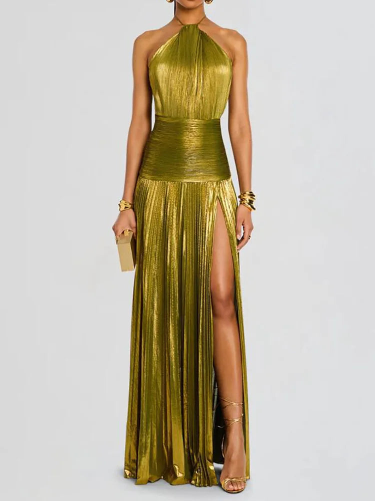 Woman wearing a metallic gold dress with a slit on a white background