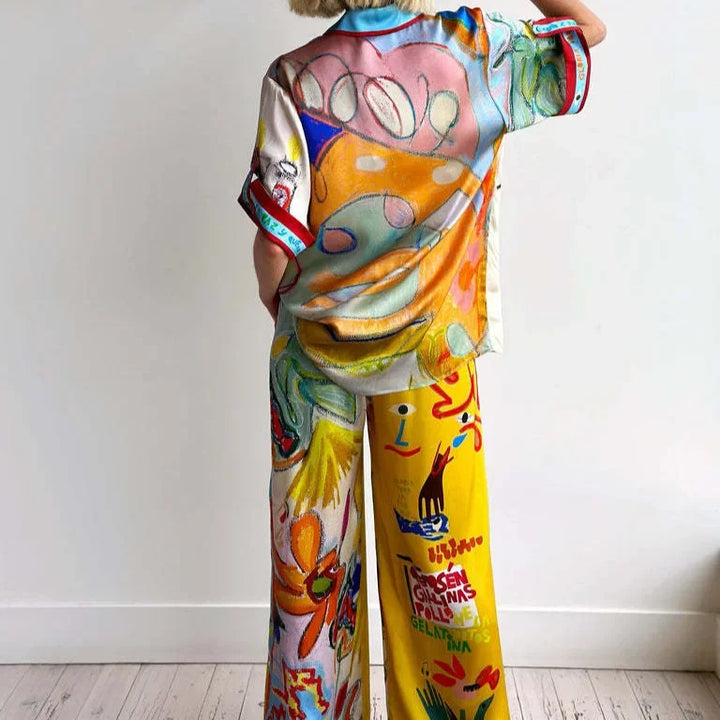 Person wearing a colorful outfit with abstract patterns on a white background