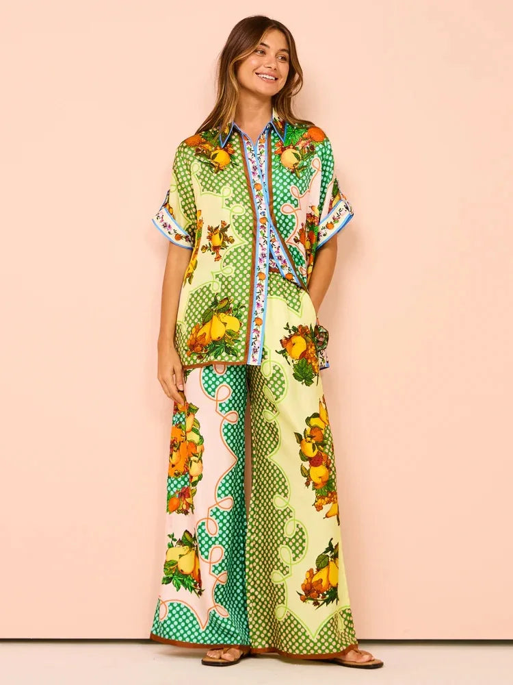 Woman wearing a colorful outfit with a pattern of fruits and geometric shapes on a beige background