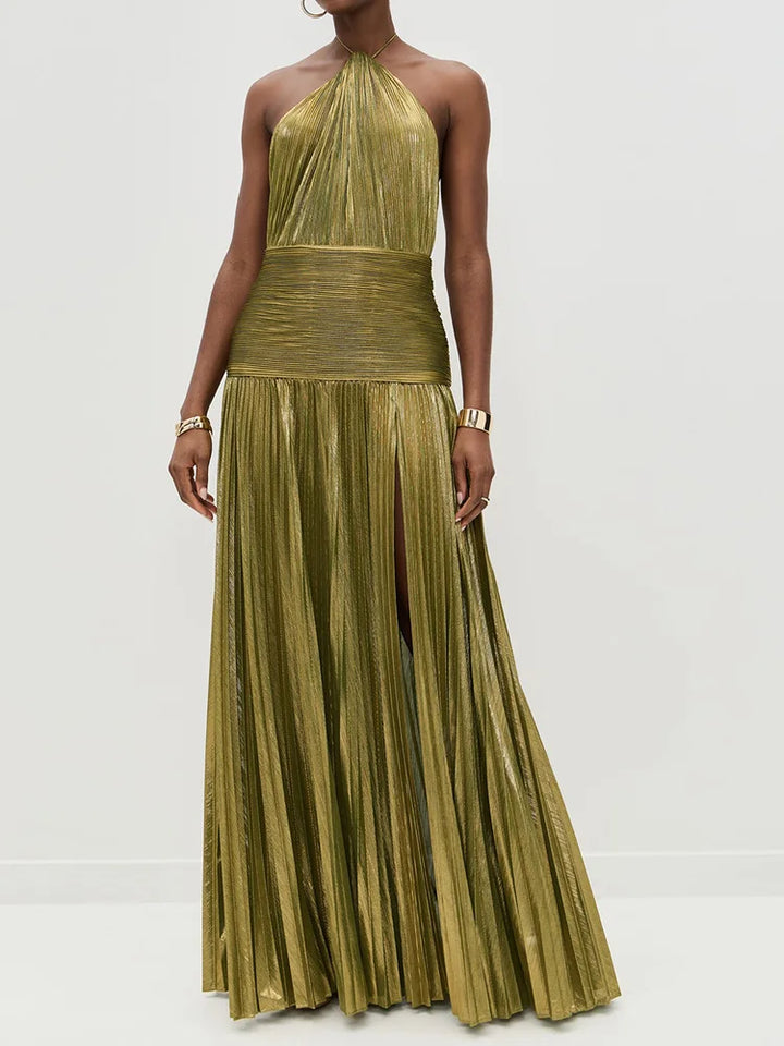 Woman wearing a gold pleated dress against a white background