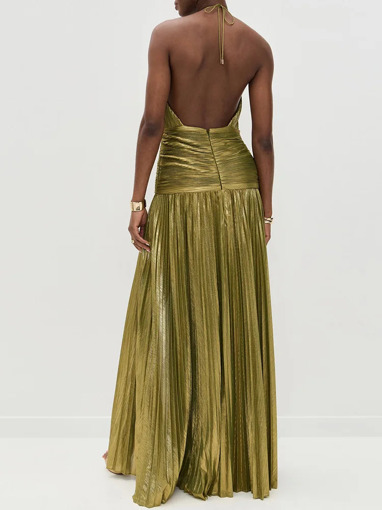 Woman wearing a gold pleated dress on a white background