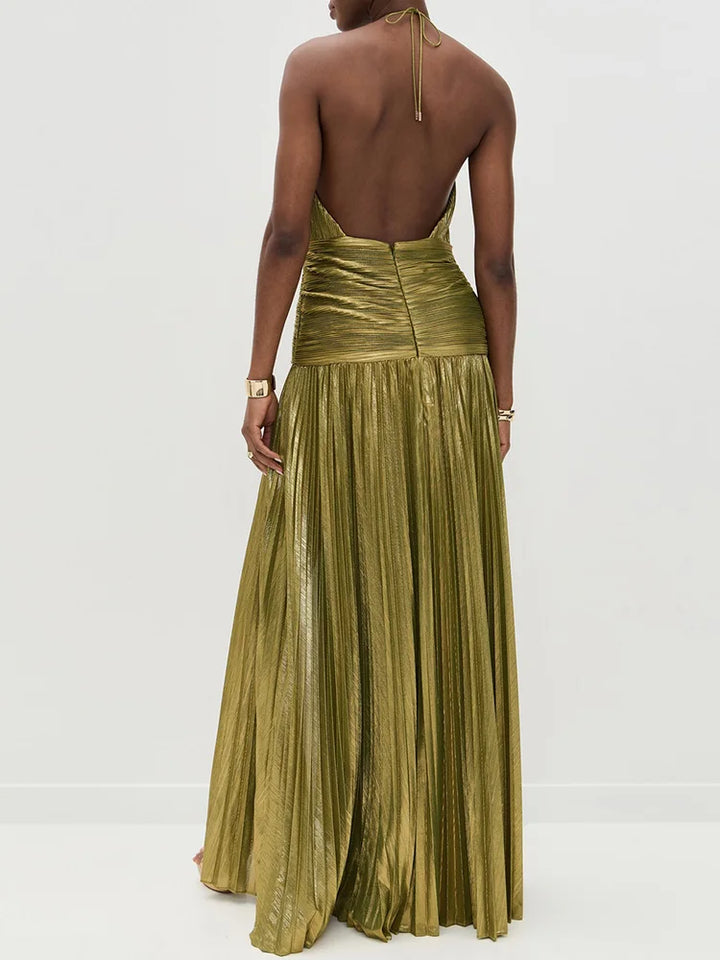 Woman wearing a gold pleated dress on a white background