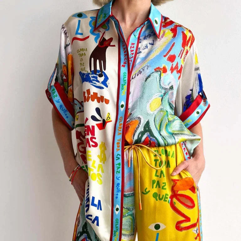 Person wearing a colorful, patterned outfit with a scarf.
