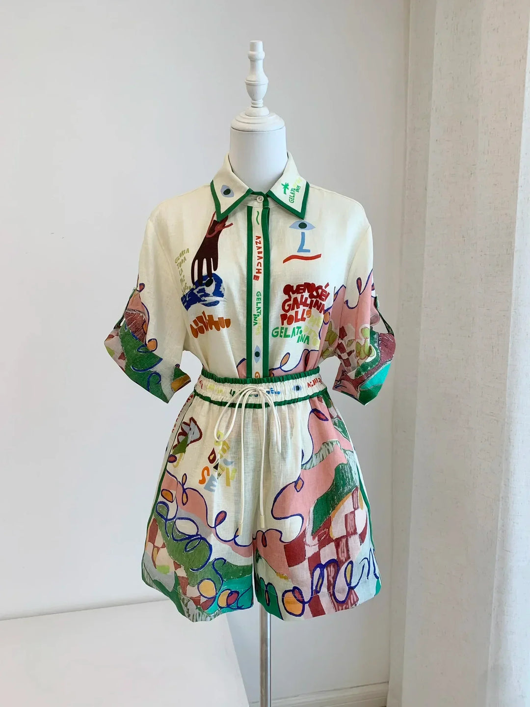 Colorful dress with abstract patterns on a mannequin against a white background