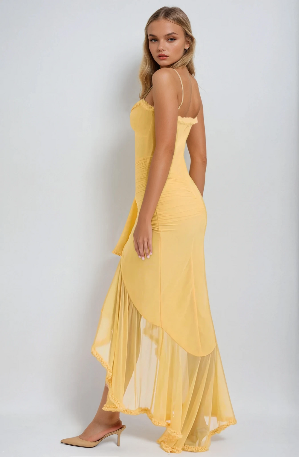 Woman wearing a yellow dress against a white background