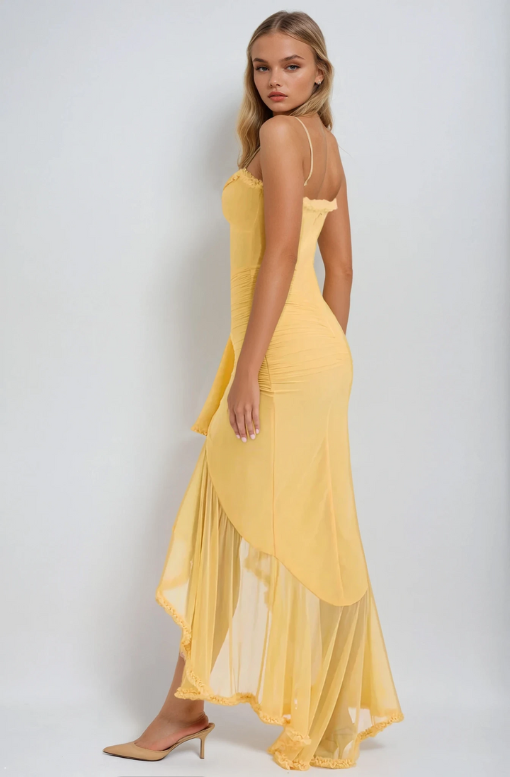 Woman wearing a yellow dress against a white background