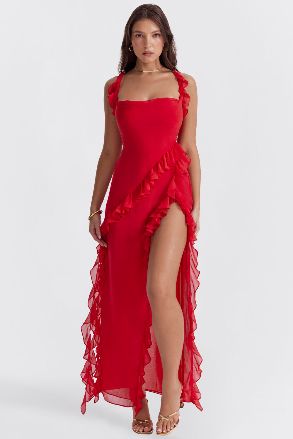 Woman wearing a red dress with ruffles on a white background