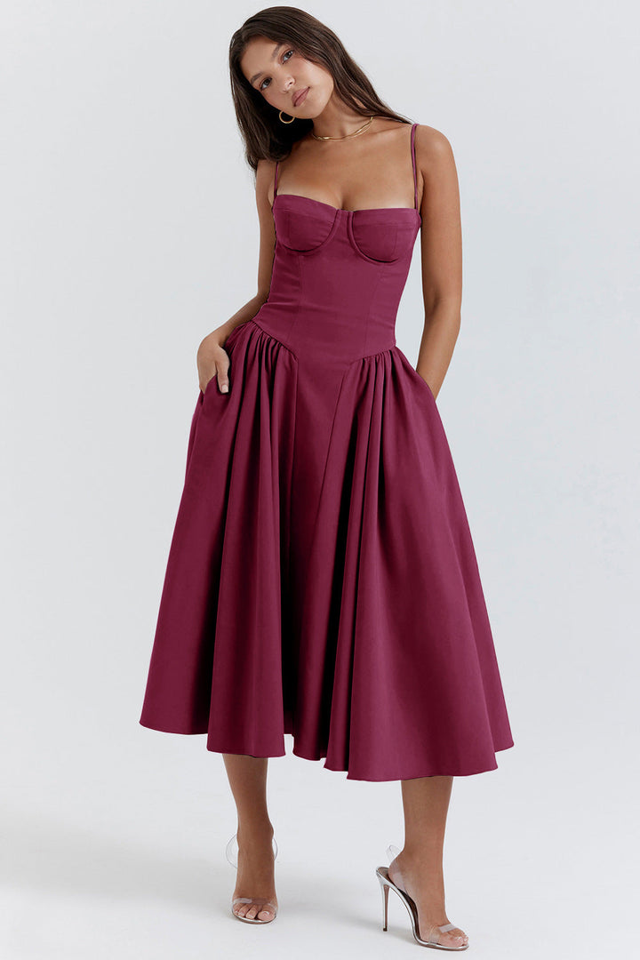 Woman wearing a burgundy dress on a white background