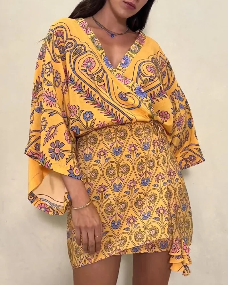 Yellow patterned dress worn by a person against a plain background
