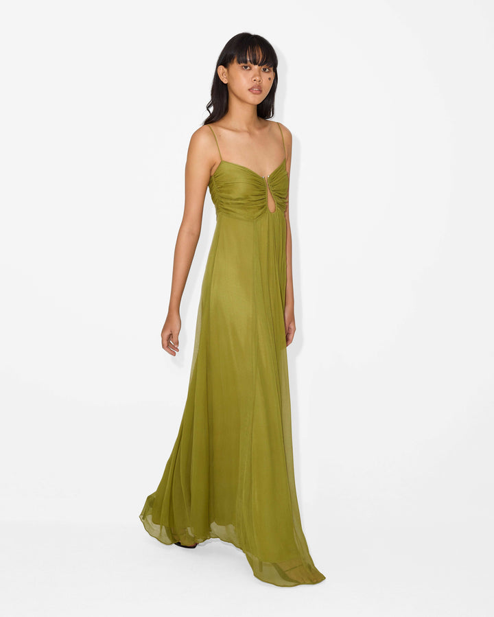 women wearing green flowing dress walking side