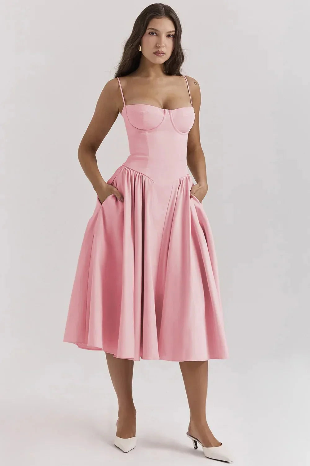 Woman wearing a pink dress on a white background