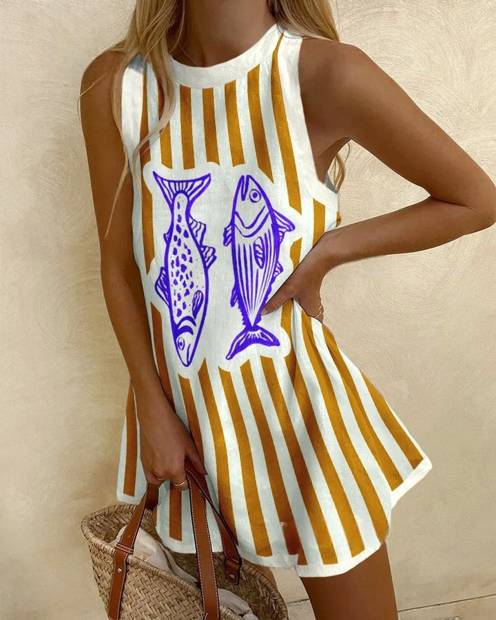 Woman wearing a yellow and white striped dress with fish design, holding a straw bag.